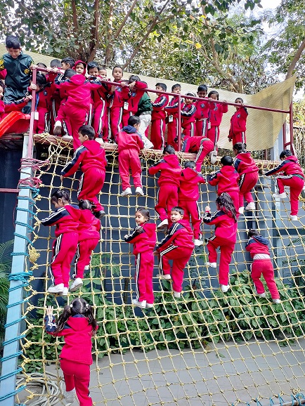 Students climbing net during outdoor activity